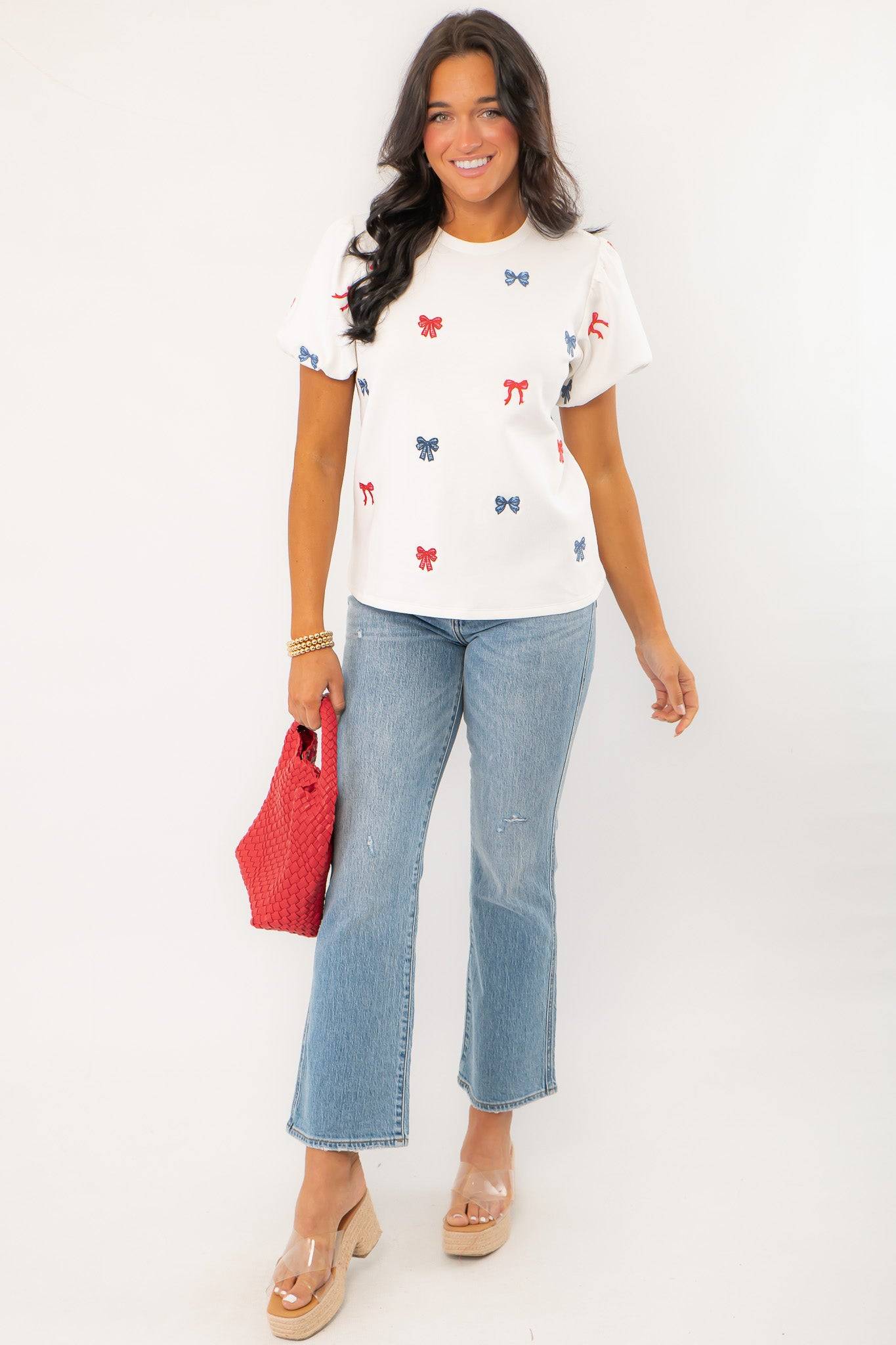 Model wearing THML Red & Blue Bow Embroidery Top with jeans, showcasing a festive and stylish patriotic outfit for summer holidays.