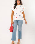 Model wearing THML Red & Blue Bow Embroidery Top with jeans, showcasing a festive and stylish patriotic outfit for summer holidays.