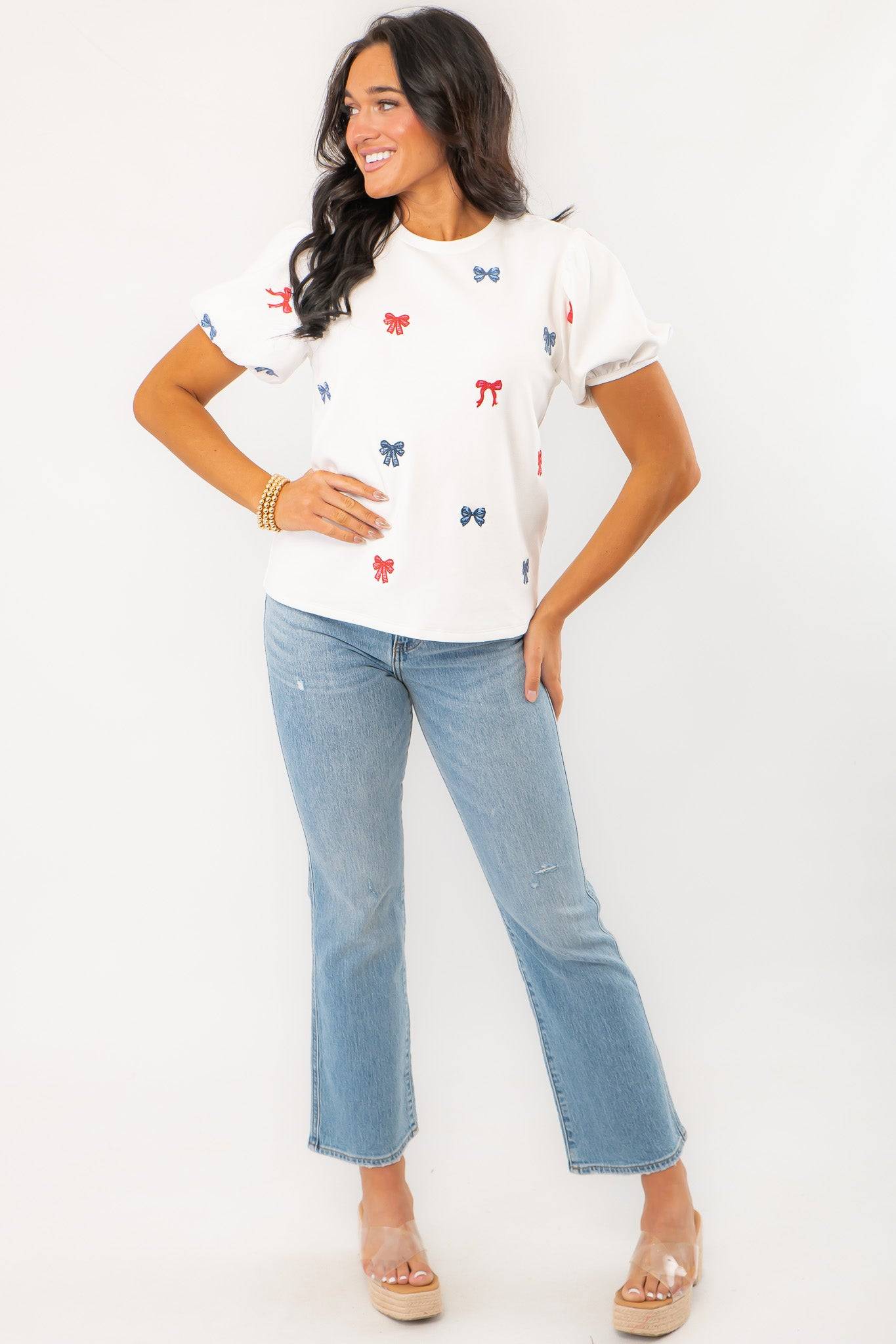 Front view of THML Red & Blue Bow Embroidery Top styled with denim, highlighting its casual yet festive design for patriotic events.