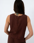 Back view of brown linen tank top with sleeveless design and relaxed fit