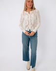 White lace long sleeve blouse with intricate embroidery and button front