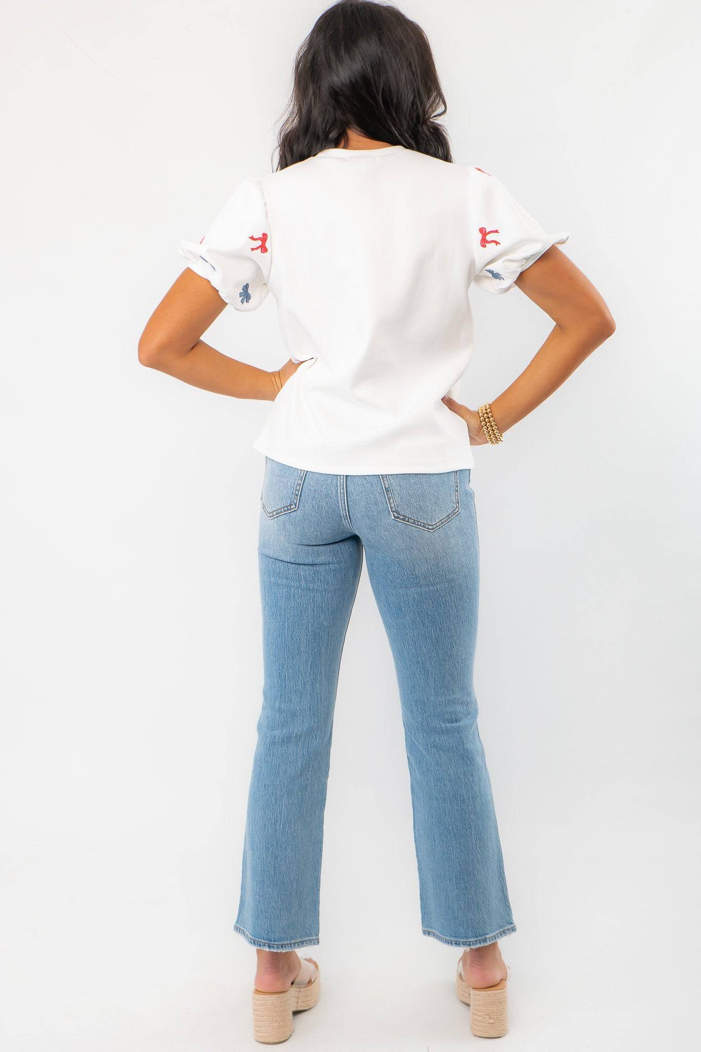 Back view of THML Red & Blue Bow Embroidery Top with subtle sleeve details, ideal for a stylish and comfortable summer outfit.