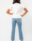 Back view of THML Red & Blue Bow Embroidery Top with subtle sleeve details, ideal for a stylish and comfortable summer outfit.