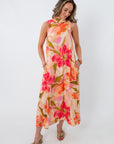 Vibrant floral maxi dress with large pink and orange flowers, sleeveless design, and pockets, perfect for wedding guests and summer occasions