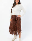 Ruffled Serene Mocha Lace Maxi Skirt paired with a white ribbed sweater, perfect for elegant boho or Thanksgiving outfits.