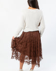 Back view of Serene Mocha Lace Maxi Skirt highlighting its sheer lace texture and elegant ruffle detailing.