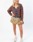 Model wearing Blue Ridge Plaid Checkered Cardigan with beige skirt and boots, showcasing a trendy fall outfit for women.