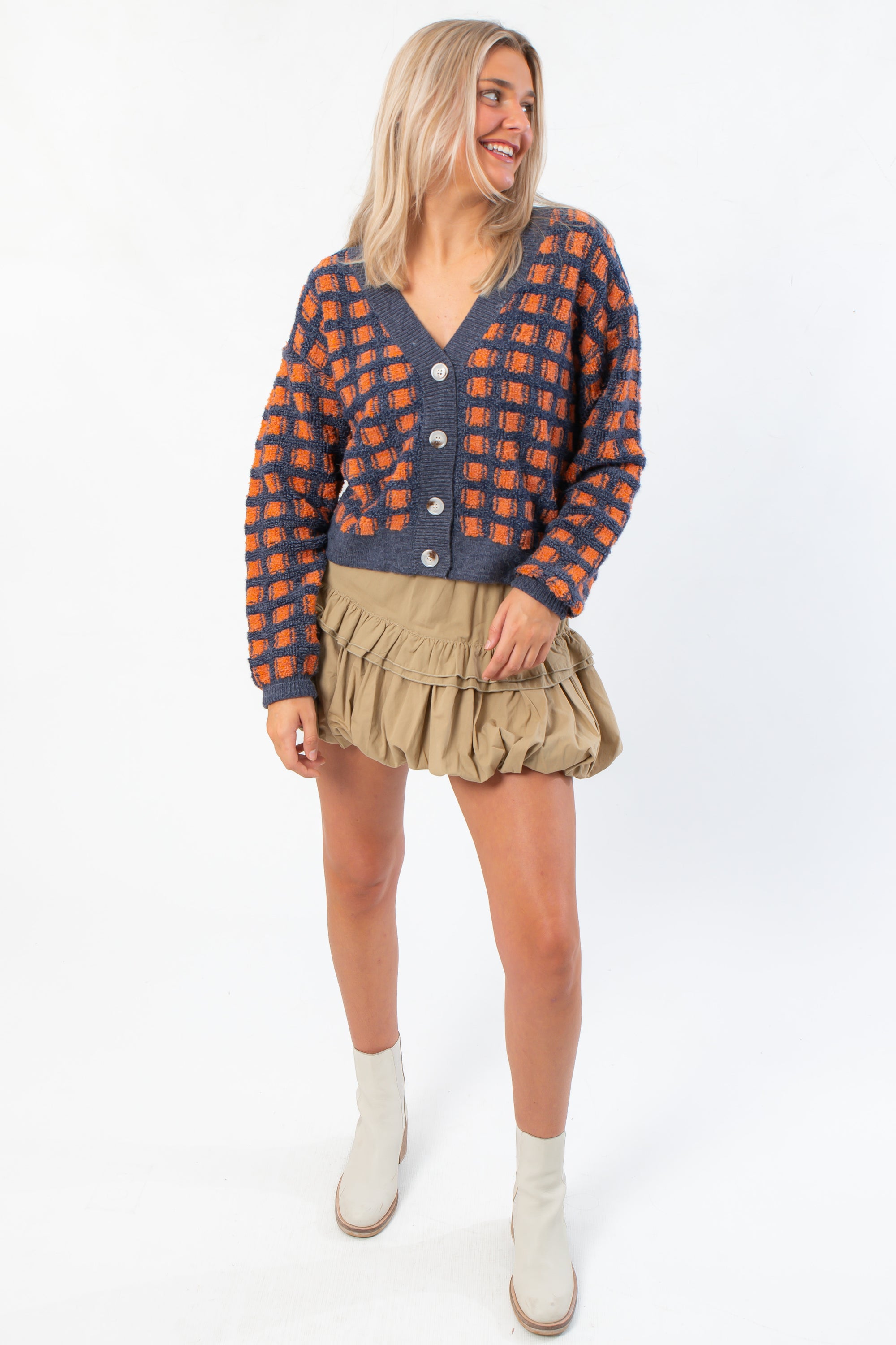 Blue Ridge Plaid Checkered Cardigan styled with neutral skirt and boots, highlighting its cozy fit and fall-ready design.