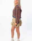 Side view of Blue Ridge Plaid Checkered Cardigan in navy and orange, showing textured knit and flattering cropped fit.