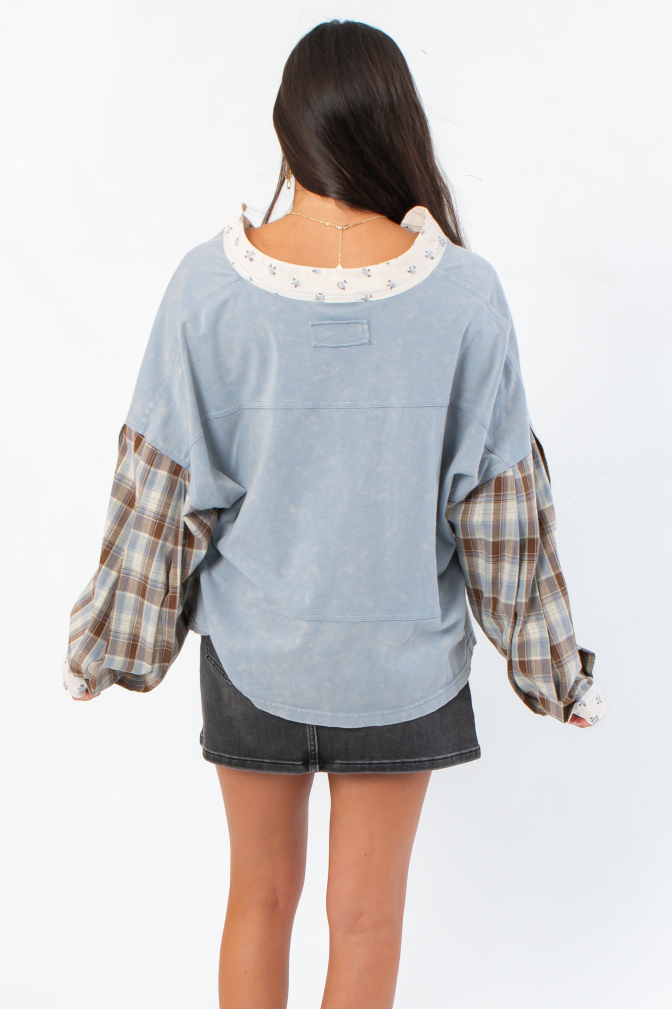 Back view of Everyday Ease Denim Patchwork Top highlighting curved hem and soft washed fabric, perfect for casual autumn outfits.
