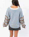 Back view of Everyday Ease Denim Patchwork Top highlighting curved hem and soft washed fabric, perfect for casual autumn outfits.