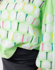 Detailed view of Queen of Sparkles Green Golf Ball & Tee Sweatshirt highlighting sparkling sequins and colorful tee embellishments.