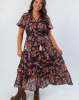 THML Burgundy Printed Puff Sleeve Tiered Maxi Dress with floral pattern and tassel tie neckline, styled for fall at L Mae Boutique.