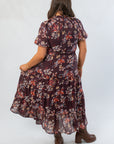 Back view of THML Burgundy Printed Puff Sleeve Tiered Maxi Dress highlighting floral design and tiered hem, great for seasonal wardrobes.