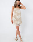 Model wearing beige floral mesh mini dress with pockets