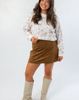 Z Supply Coconut Ciera Suede Mini Skirt paired with a printed sweatshirt and boots, showcasing a chic and versatile fall outfit.
