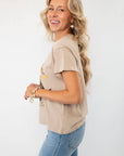 Side view of the Daydreamer Willie Nelson 'A Horse Called Music' Graphic Tee, featuring a relaxed fit and soft beige cotton fabric.
