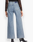 Back view of Daze Denim Far Out High Rise Studded Jeans with a flattering high-waisted fit and wide-leg silhouette.