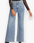 Daze Denim Far Out High Rise Studded Jeans featuring a wide-leg fit and shimmering crystal embellishments. Perfect for a bold and stylish look.