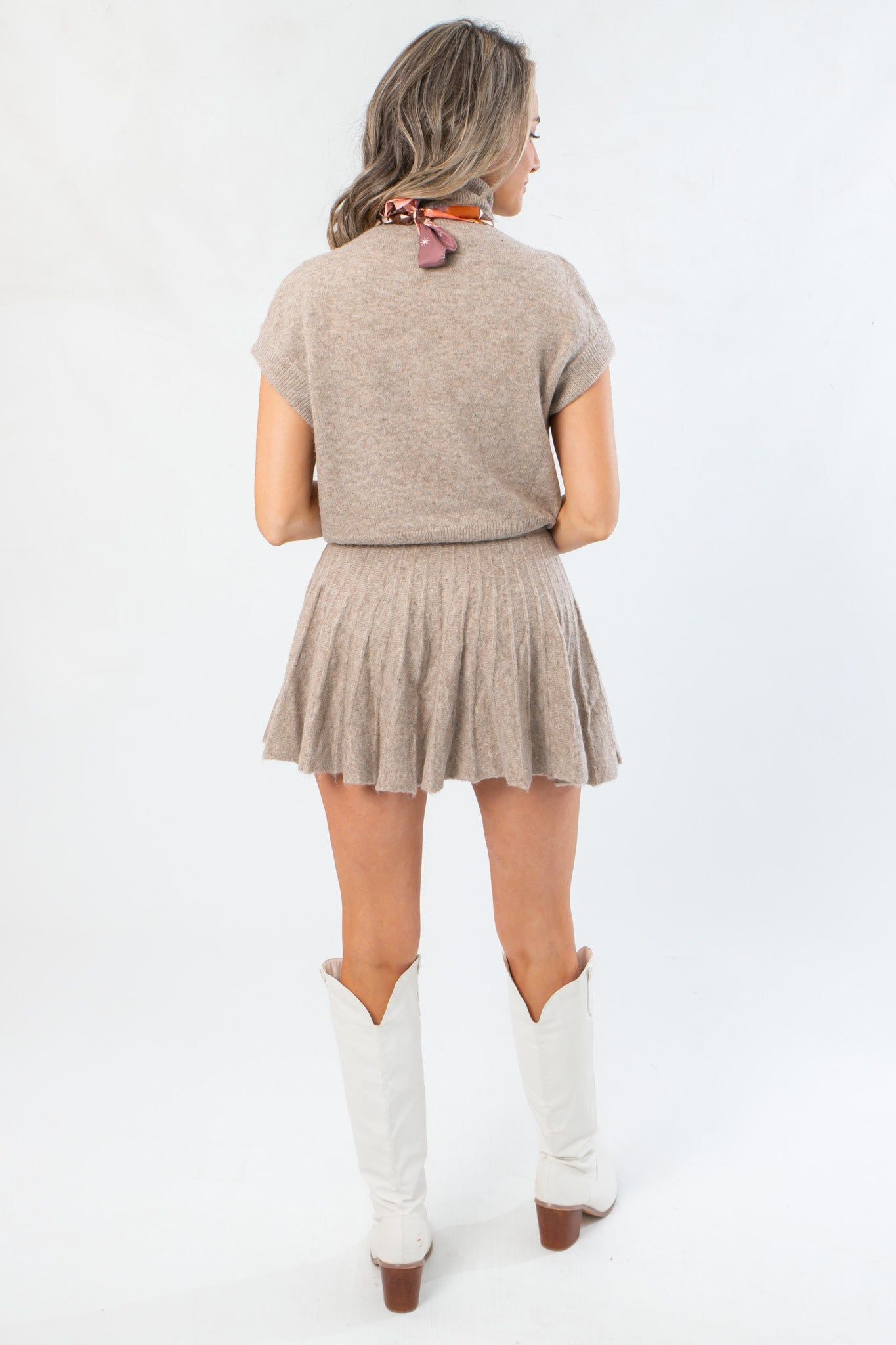 Back view of Call Me Back Skirt Set-Dark Taupe Knit showing short-sleeve turtleneck and flared pleated skirt. Ideal for fall fashion layering.