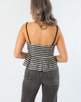 Back view of Girly Girl Shiny Black Gingham Peplum Top highlighting smocked back and peplum silhouette for a chic finish.