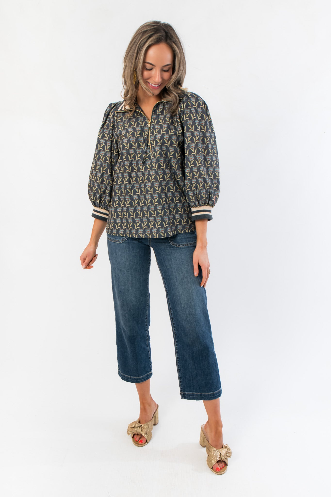 Model wearing Kut Charlotte Reflective High Rise Wide Leg Jean with a patterned blouse, showcasing its flattering high rise and relaxed fit.
