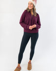 Spanx Very Black Full Length Leggings – Women’s Slimming Leggings styled with a burgundy pullover and winter hat, ideal for casual wear.