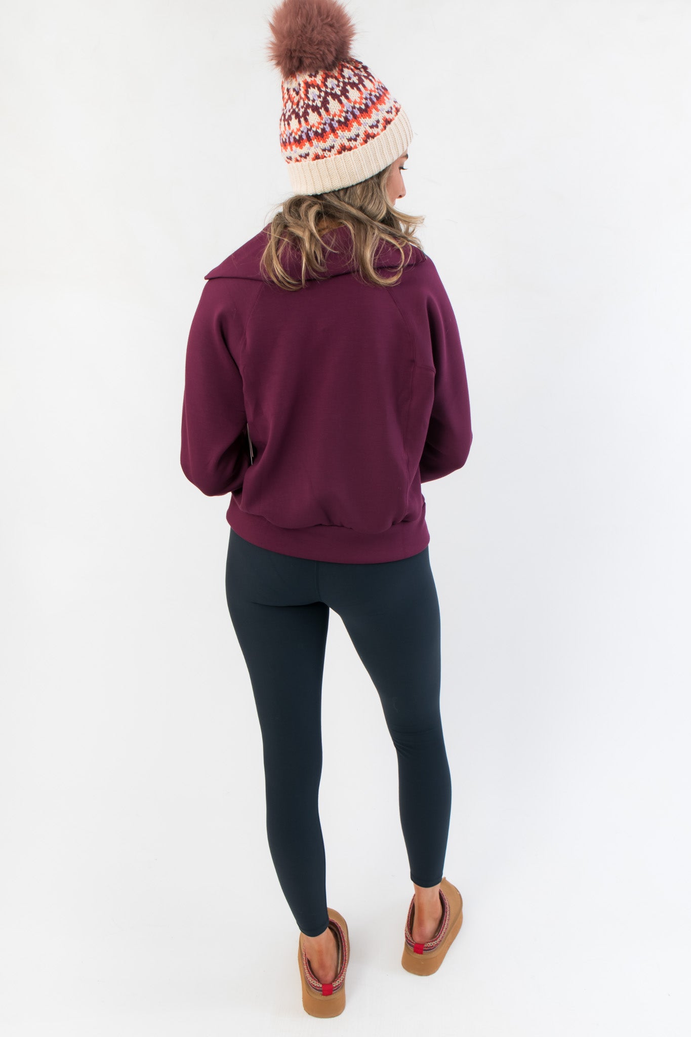 Back view of Spanx Plum Berry Air Essentials Half Zip Sweatshirt – Women’s Pullover, highlighting the sweatshirt’s structure and drop-shoulder design.