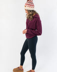Side profile of Spanx Plum Berry Air Essentials Half Zip Sweatshirt showing relaxed fit and soft fabric, styled with casual loungewear.