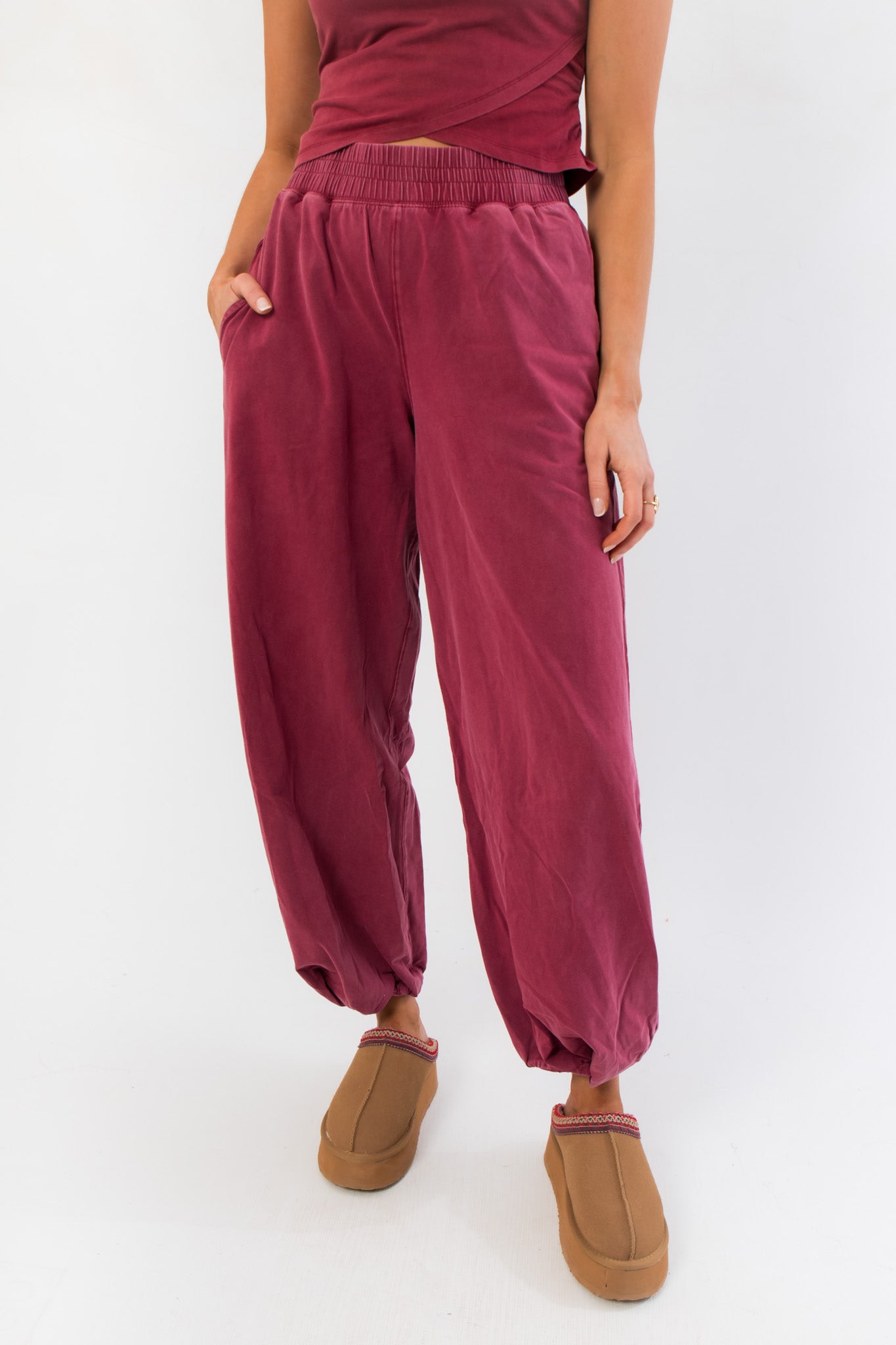 Close-up of Winterberry Elastic Waist Jogger Sweatpants showing elastic waistband, side pockets, and soft berry red fabric for casual comfort.