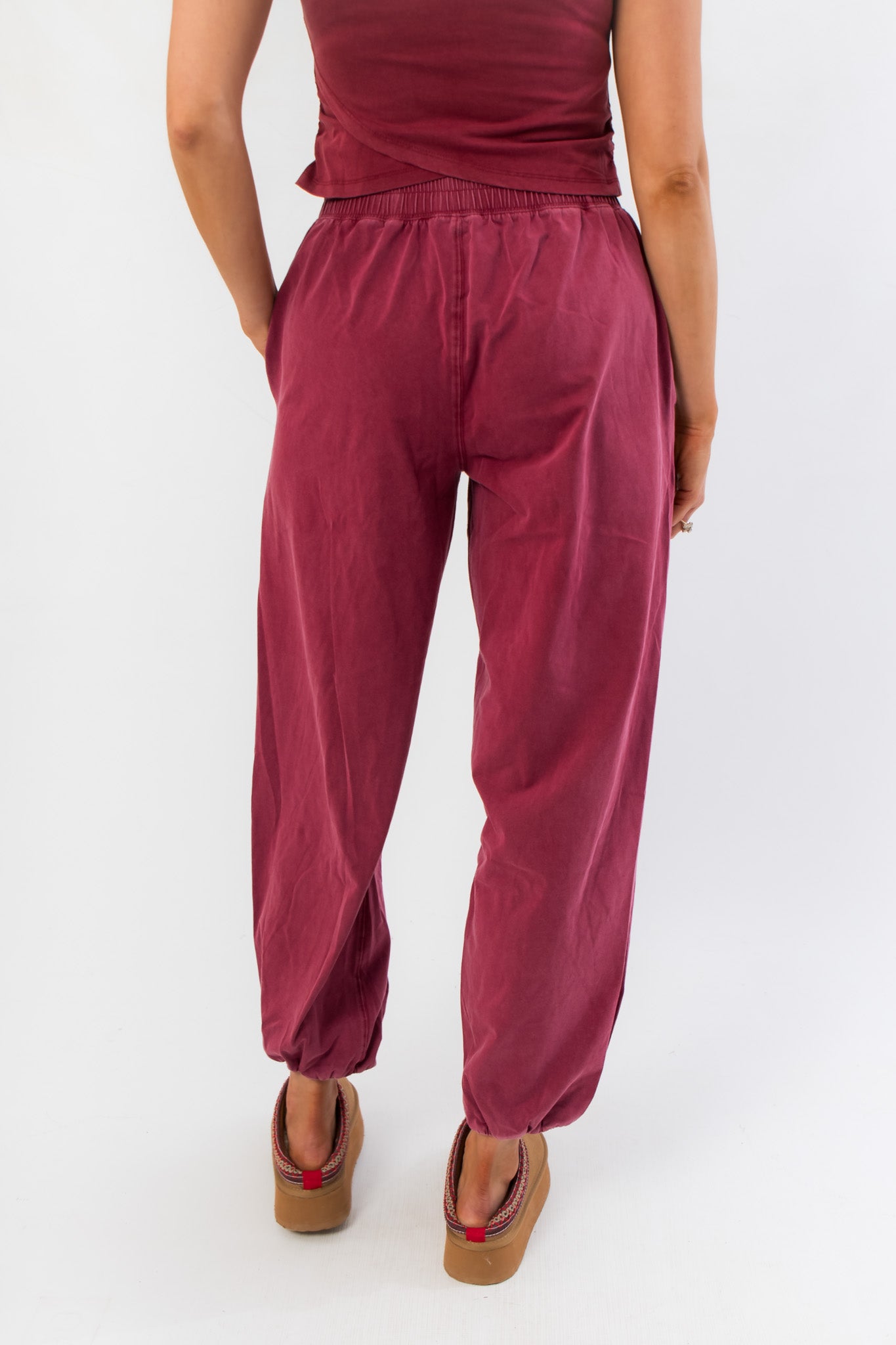 Rear close-up of Winterberry Elastic Waist Jogger Sweatpants featuring soft berry red fabric, elastic waistband, and gathered ankle hems.