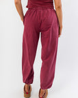 Rear close-up of Winterberry Elastic Waist Jogger Sweatpants featuring soft berry red fabric, elastic waistband, and gathered ankle hems.