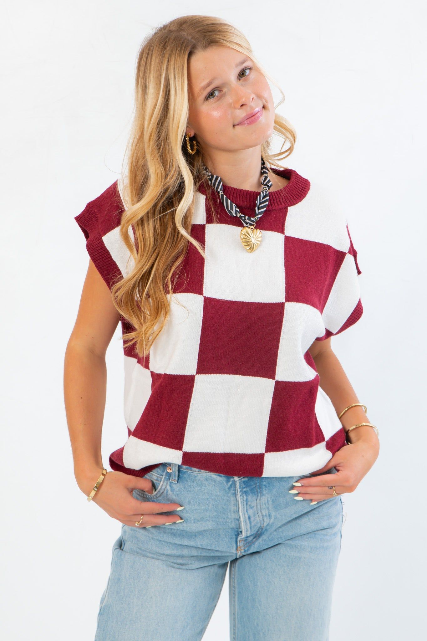 Checkmate Burgundy Sweater Vest with bold burgundy and white checker print, styled sleeveless for perfect fall layering over light tops.