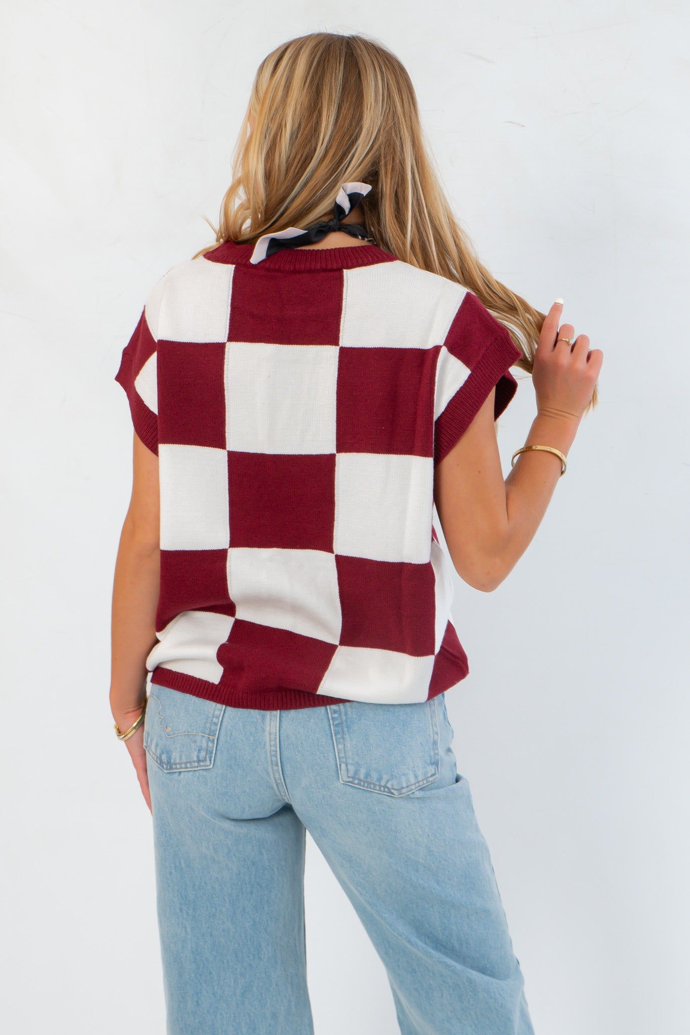 Back view of Checkmate Burgundy Sweater Vest showing oversized checker pattern and relaxed fit, ideal for transitional fall outfits.