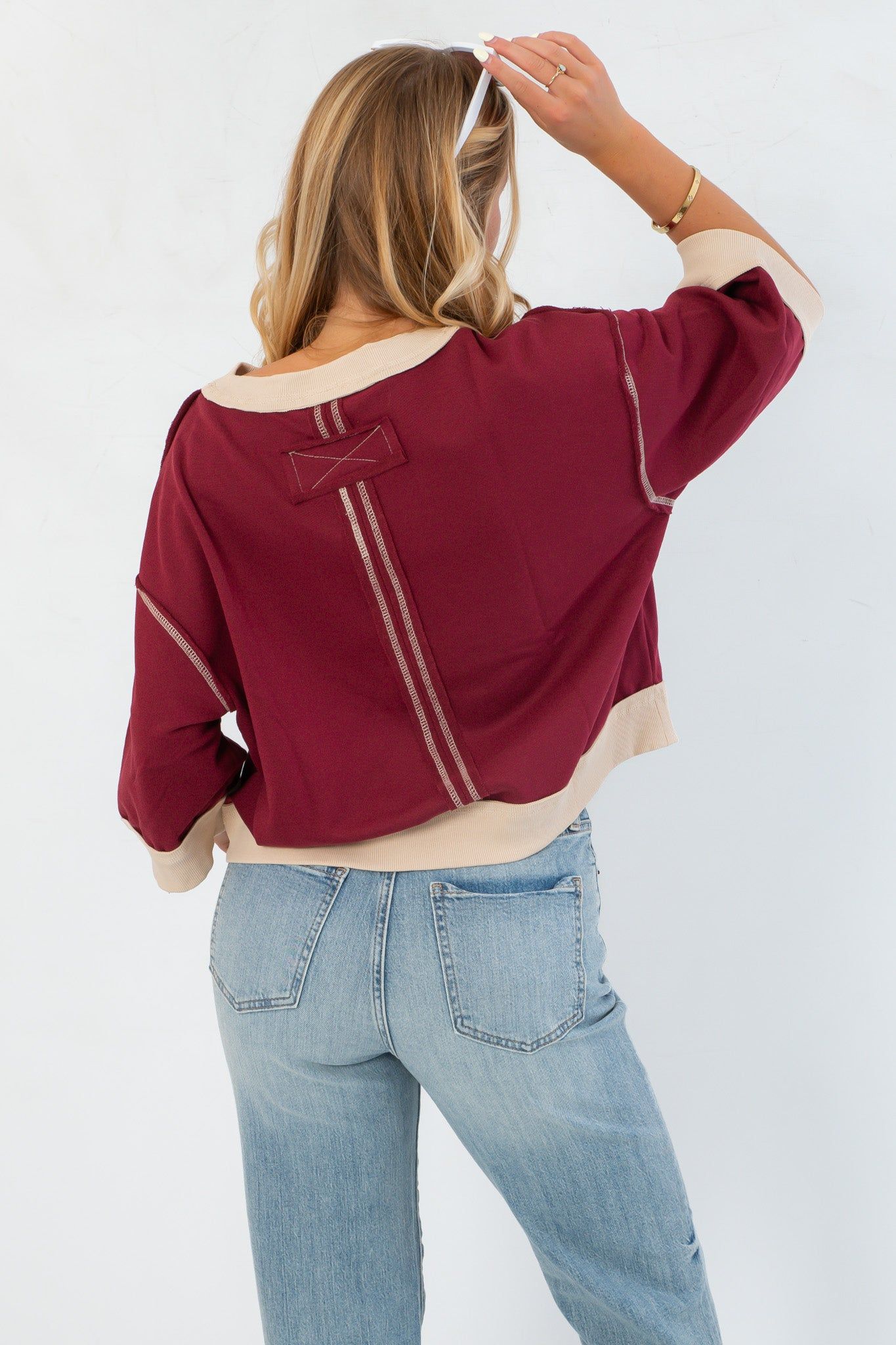 Back view of Vickie Sweatshirt featuring contrast stitching and a unique patch detail, combining comfort with standout design.