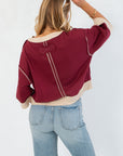 Back view of Vickie Sweatshirt featuring contrast stitching and a unique patch detail, combining comfort with standout design.