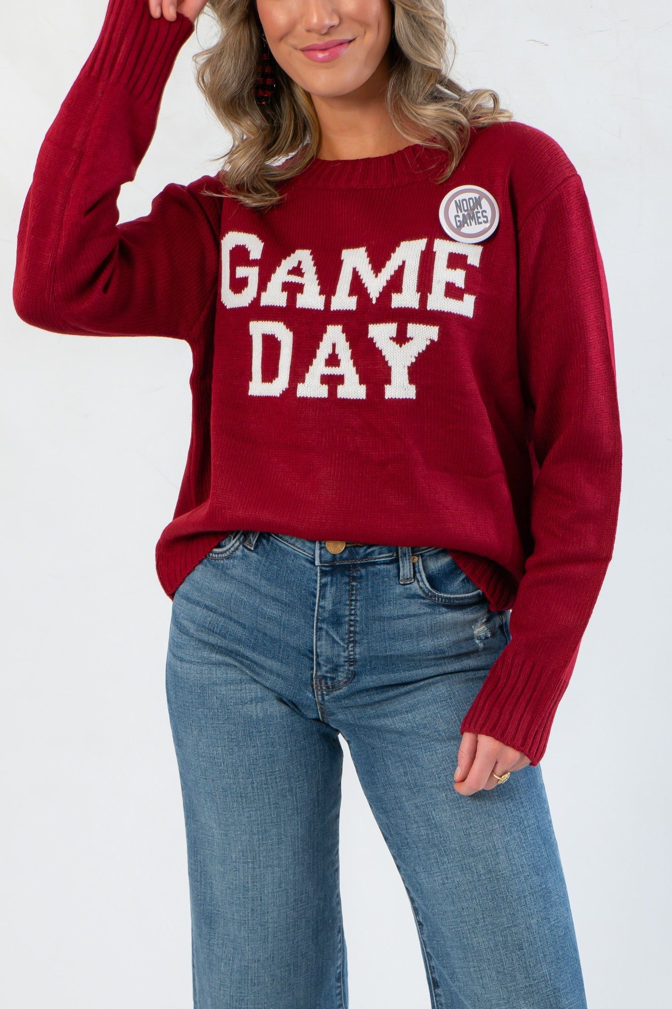 Close-up of Game Day Garnet Knit Sweater showing textured knit fabric, white GAME DAY lettering, and cozy oversized design.