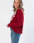 Side view of Game Day Garnet Knit Sweater highlighting relaxed fit, ribbed hem, and soft knit texture ideal for layering.