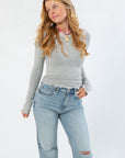 Free People Heather Grey Oh My Darling Long Sleeve top with lace neckline and slim fit, styled with light wash jeans for a casual fall look.