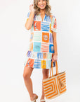 Discover seaside chic with THML At Sea Nautical Printed Dress featuring colorful ocean-themed blocks, short sleeves, and a relaxed fit.