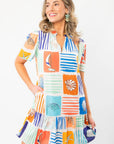 Front view of THML At Sea Nautical Printed Dress with playful ocean motifs, v-neckline, and flutter sleeves perfect for vacation wear.