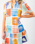 Close-up of THML At Sea Nautical Printed Dress showcasing vibrant nautical graphics, soft fabric, and tiered ruffle hem for summer style.