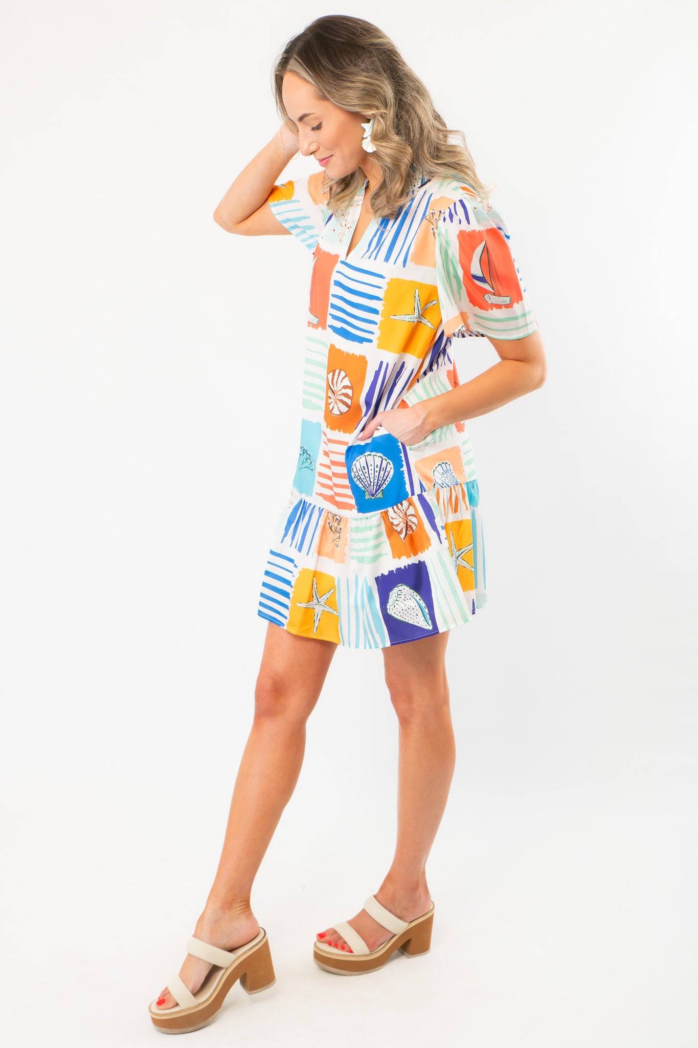 Side view of THML At Sea Nautical Printed Dress highlighting its breezy silhouette, colorful marine prints, and flared skirt design.
