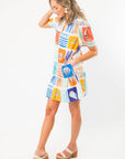 Side view of THML At Sea Nautical Printed Dress highlighting its breezy silhouette, colorful marine prints, and flared skirt design.
