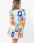 Back view of THML At Sea Nautical Printed Dress showing tiered hem and vibrant seaside illustrations ideal for beach or resort outings.