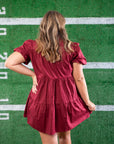 Back view of the Garnet Sequin Football Dress, showcasing its tiered silhouette and puff sleeves. A must-have short dress for stylish football lovers.
