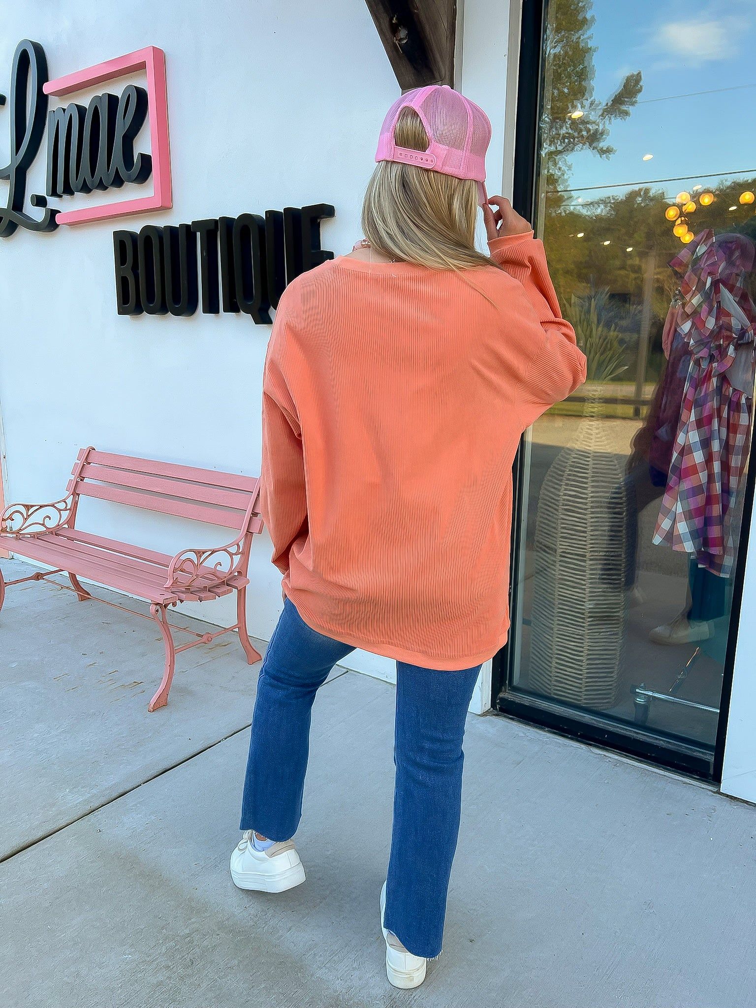 Back view of Orange Ribbed Sequin Ghost Sweatshirt showing ribbed texture and relaxed fit, perfect for casual Halloween looks.