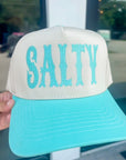 Trucker hat with 'SALTY' in turquoise on a white background