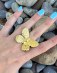Close-up of Golden Monarch gold butterfly ring on finger, showcasing detailed wing texture and polished finish. Statement butterfly ring for special occasions.