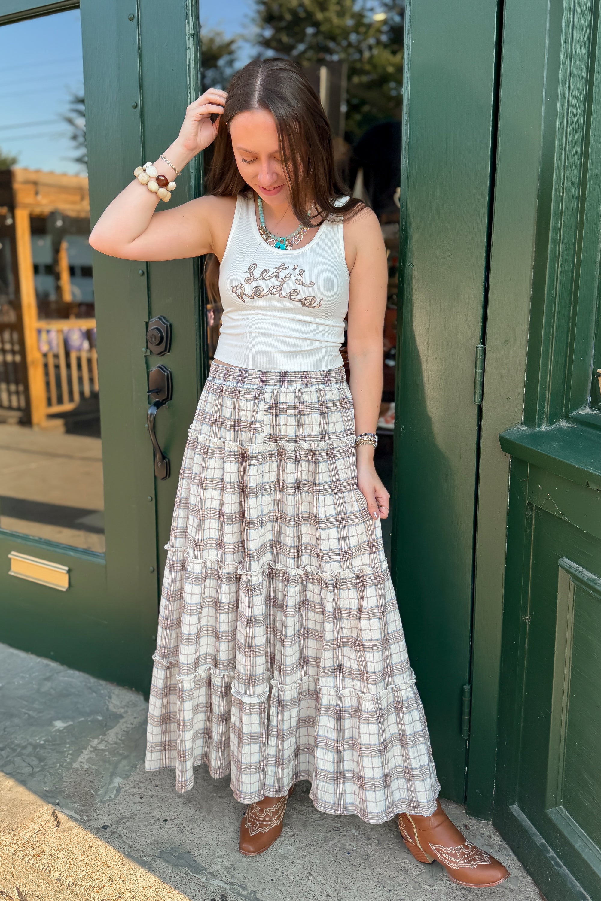 Fort Worth Brown Plaid Maxi Skirt styled with a white tank top and western boots, perfect for casual fall fashion.
